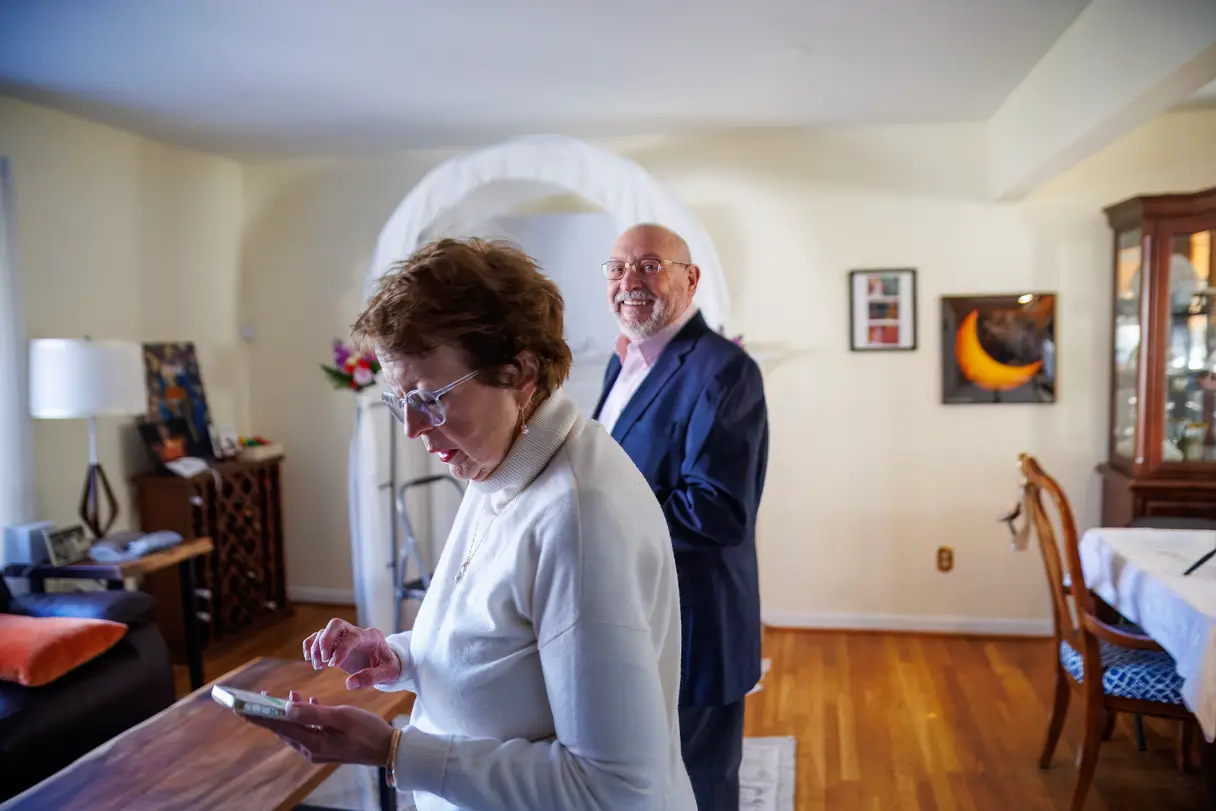 Candid photograph of a couple sharing a quiet moment at an evening event.