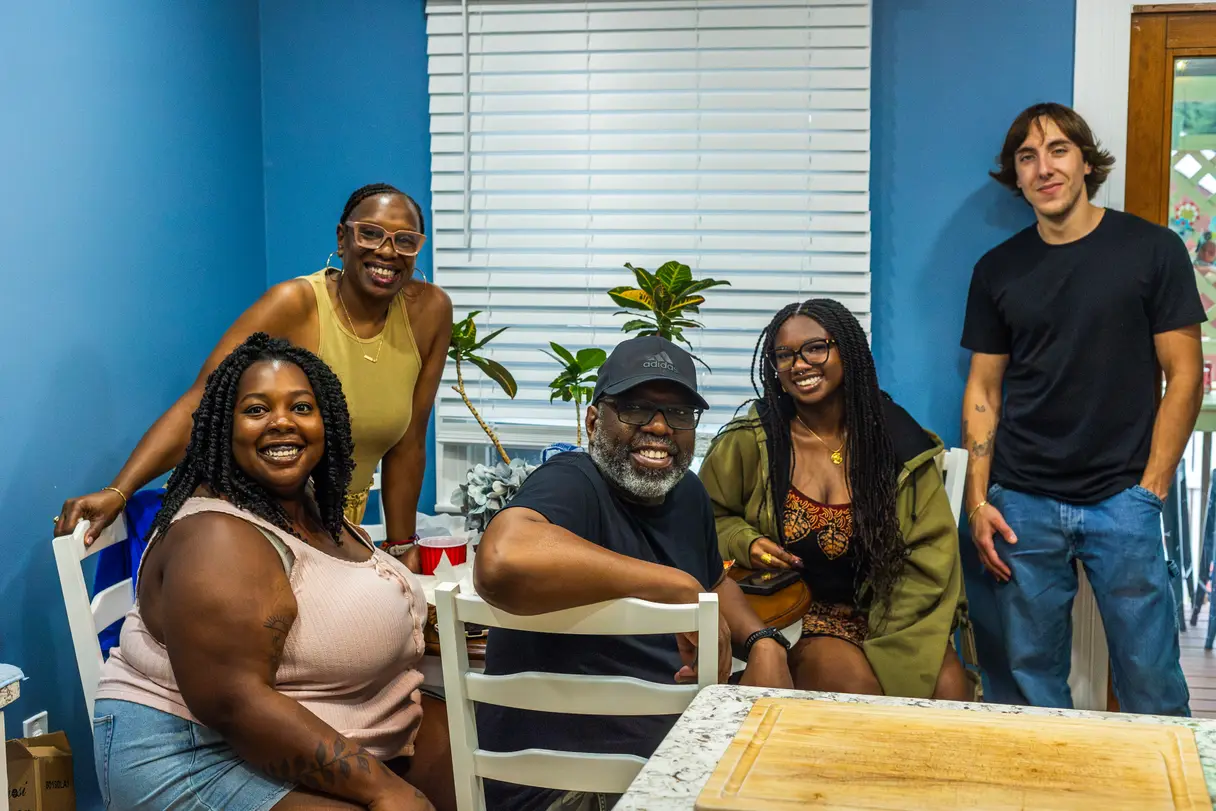 Family at a table enjoying each other's company at a birthday party.